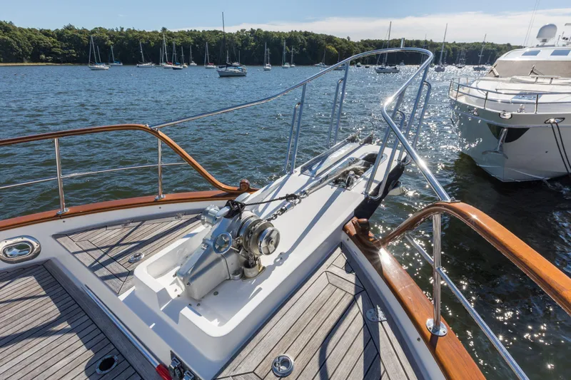 Slide: The Image of Bow of 2006 Grand Banks 59 Aleutian RP yacht with anchor, on a sunny day. - 30