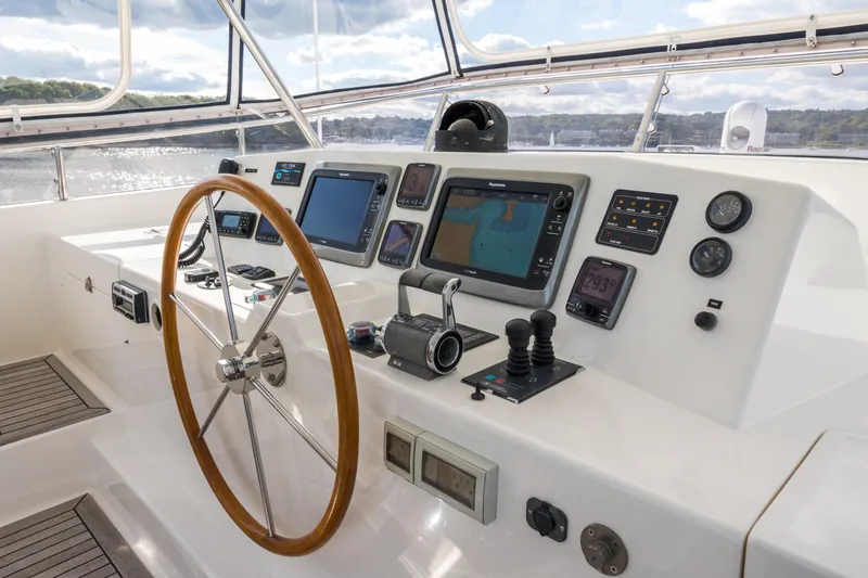 Slide: The Image of Helm of 2006 Grand Banks 59 Aleutian RP yacht with navigation equipment and wooden steering wheel. - 37