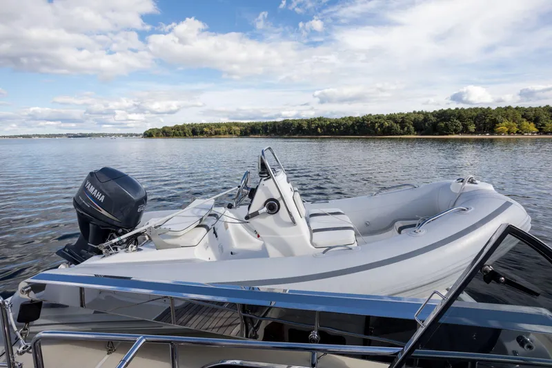 Slide: The Image of 2006 Grand Banks 59 Aleutian RP yacht with inflatable boat on calm water. - 38