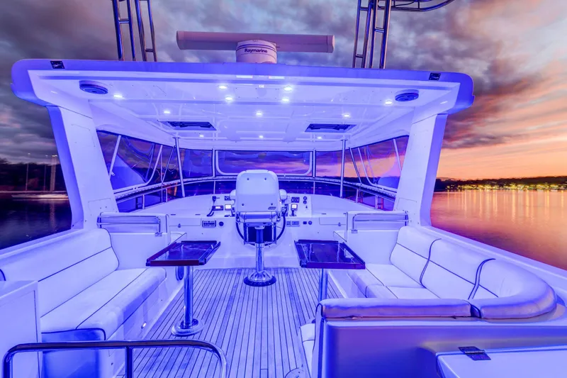 Slide: The Image of Luxurious 2006 Grand Banks 59 Aleutian RP yacht interior at sunset, featuring elegant seating and ambient lighting. - 39