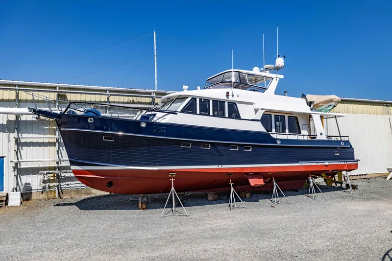 Slide: The Image of 2006 Grand Banks 59 Aleutian RP yacht on dry dock, blue hull, white superstructure. - 49