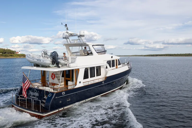 Slide: The Image of 2006 Grand Banks 59 Aleutian RP yacht cruising on open water, rear view. - 51