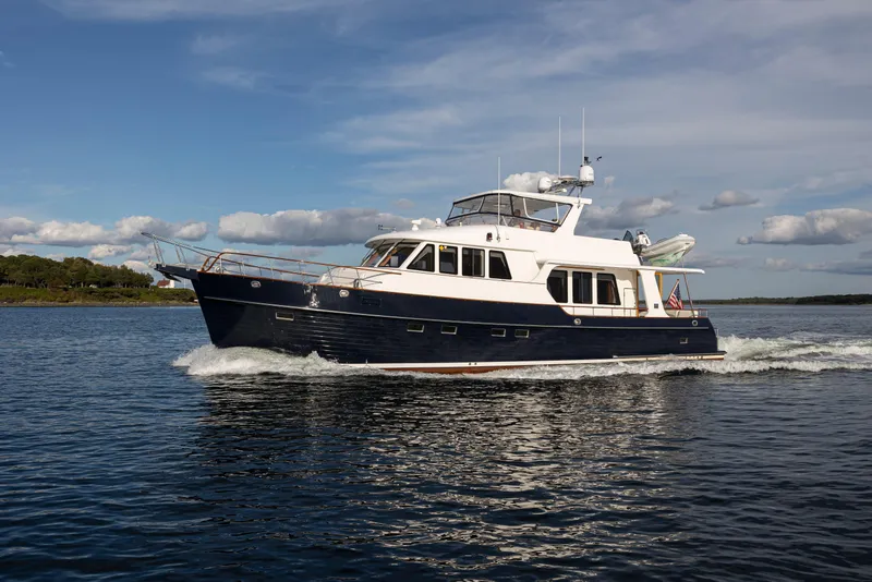 Slide: The Image of 2006 Grand Banks 59 Aleutian RP yacht cruising on open water under a blue sky. - 52