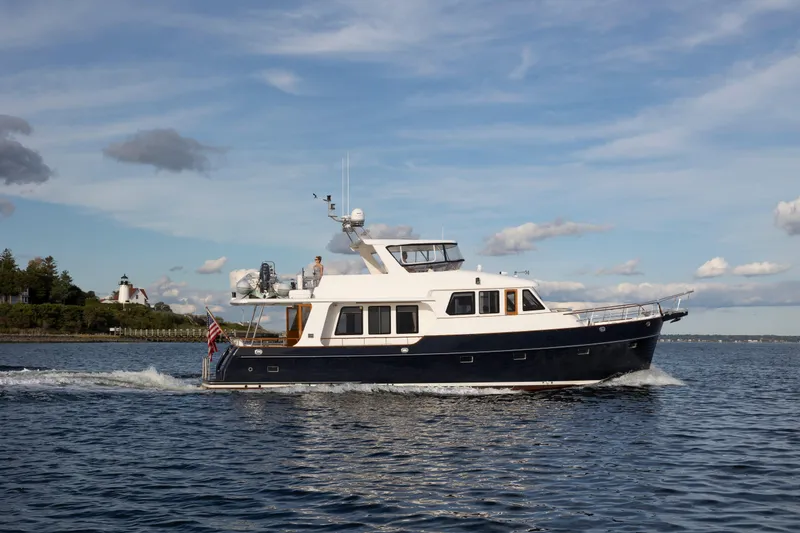 Slide: The Image of 2006 Grand Banks 59 Aleutian RP yacht cruising on open water under a clear sky. - 54
