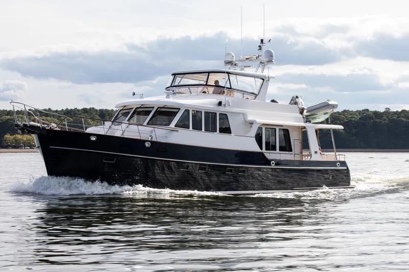 Slide: The Image of 2006 Grand Banks 59 Aleutian RP yacht cruising on calm waters. - 55