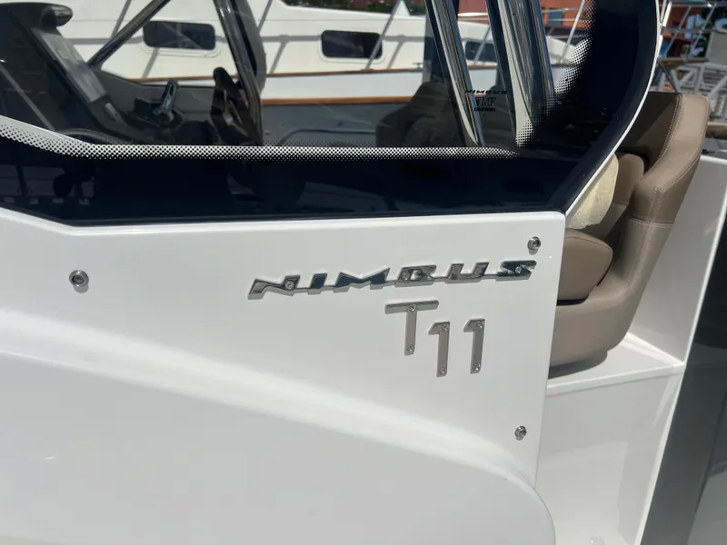 Slide: The Image of 2024 Nimbus T11 boat, sleek design with modern seating and windshield. - 12