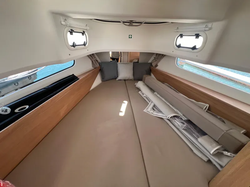 Slide: The Image of 2024 Nimbus T11 cabin interior with cozy bedding and cushions. - 19