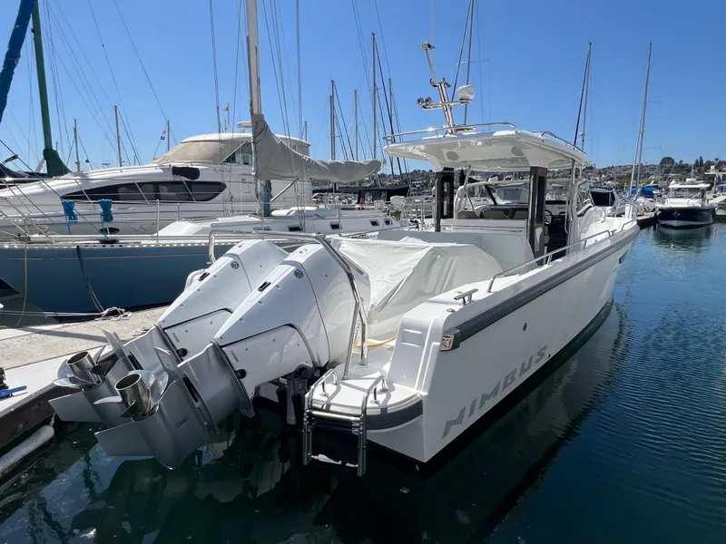 Slide: The Image of 2024 Nimbus T11 boat docked in marina with twin outboard engines. - 2