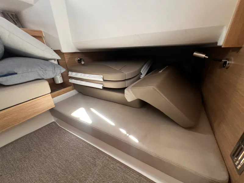 Slide: The Image of 2024 Nimbus T11 interior storage with cushions and bedding. - 21