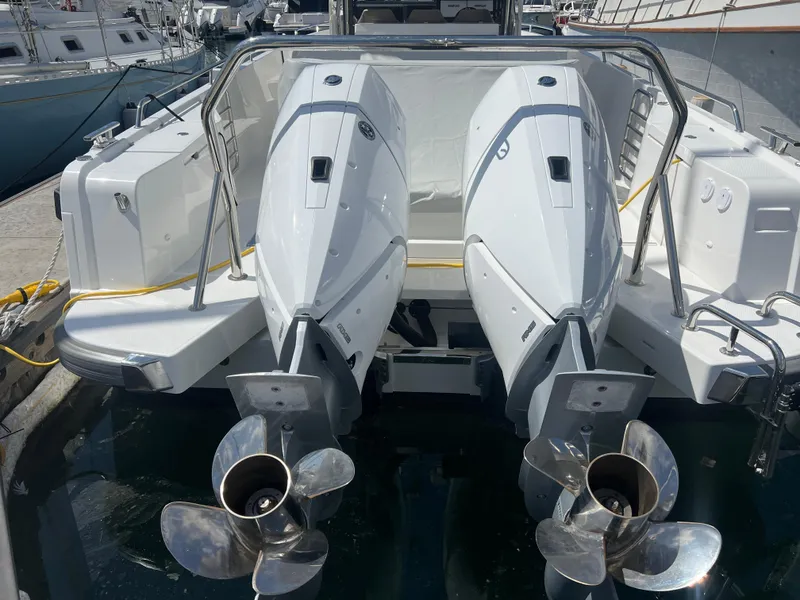 Slide: The Image of 2024 Nimbus T11 boat with dual outboard engines at a marina. - 7
