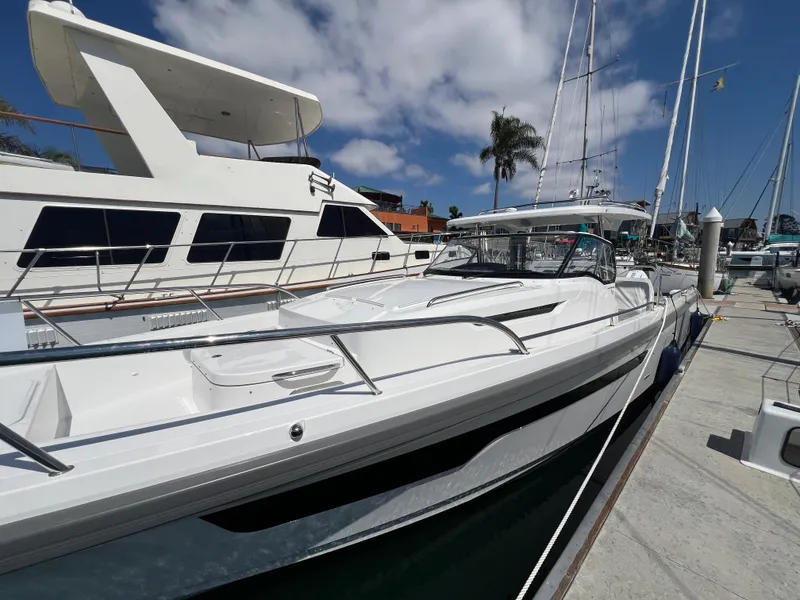 Slide: The Image of 2024 Nimbus T11 boat docked at marina under blue sky. - 8