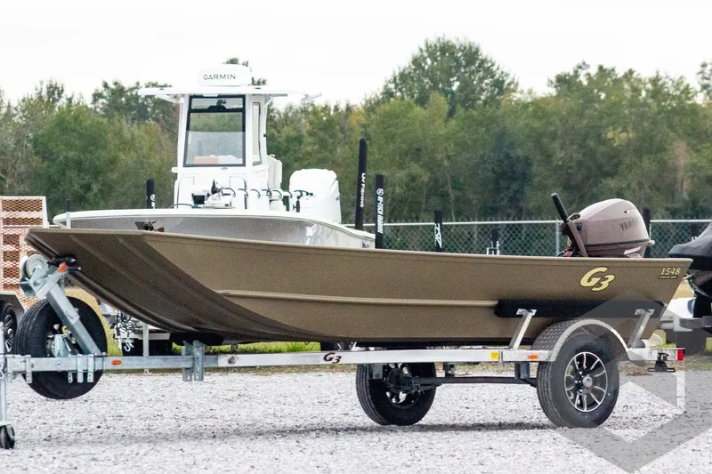 The Image of 2026 G3 Gator Tough 1548 VBW boat on trailer, outdoors with trees in background. - 1