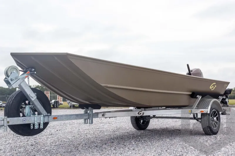 Slide: The Image of 2026 G3 Gator Tough 1548 VBW boat on trailer, parked on gravel. - 7