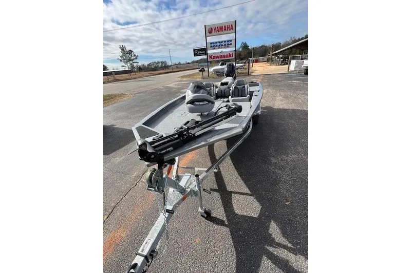 Slide: The Image of 2026 G3 Sportsman 1710 SE boat on trailer, parked outdoors near dealership signs. - 2