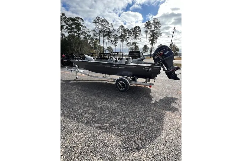 Slide: The Image of 2026 G3 Sportsman 1710 SE boat on trailer, parked outdoors under cloudy sky. - 6