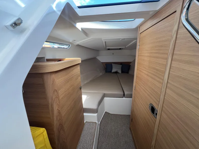 Slide: The Image of 2024 Nimbus W9 boat interior with cozy cabin and modern wood finish. - 12