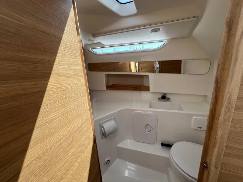 Slide: The Image of Modern bathroom interior in 2024 Nimbus W9 boat, featuring wood accents and sleek design. - 15