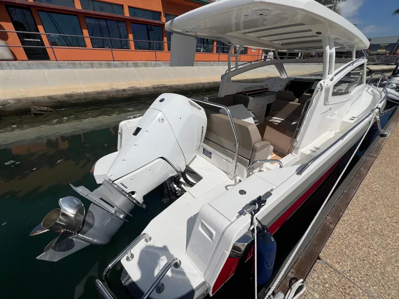 Slide: The Image of 2024 Nimbus W9 boat docked, featuring sleek design and powerful outboard motor. - 3