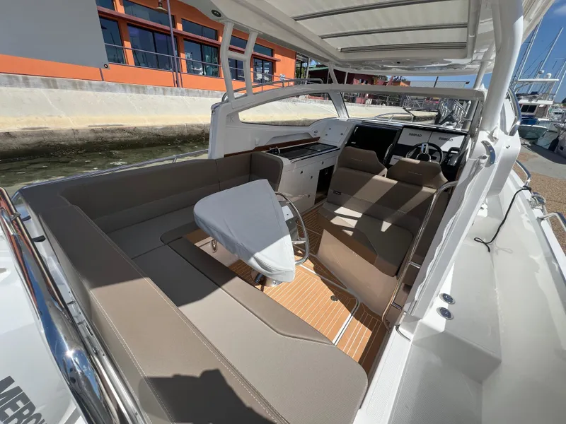 Slide: The Image of 2024 Nimbus W9 boat interior with beige seating and modern dashboard. - 4