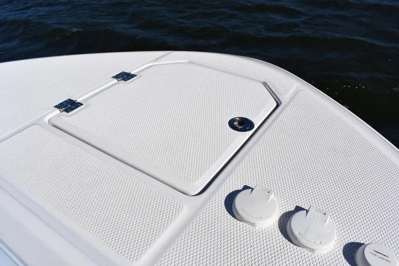 Slide: The Image of 2022 Robalo R272 Center Console boat deck with storage hatch and water access. - 11
