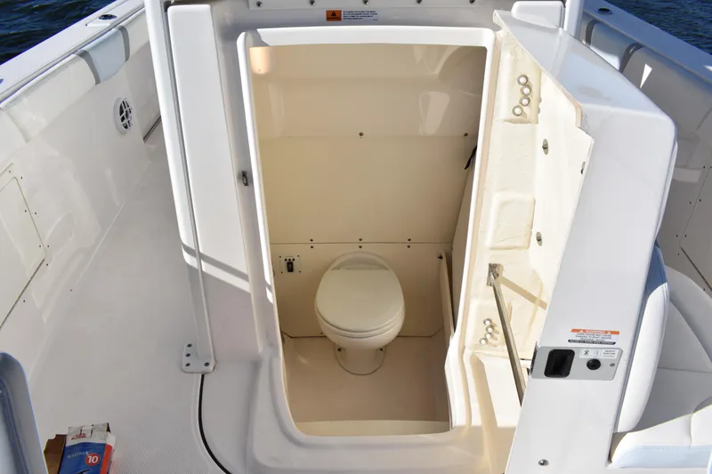 Slide: The Image of 2022 Robalo R272 Center Console boat with onboard toilet compartment. - 14