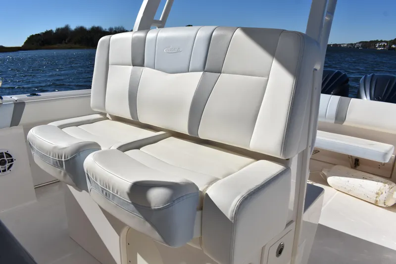 Slide: The Image of 2022 Robalo R272 Center Console boat with white cushioned seating. - 21