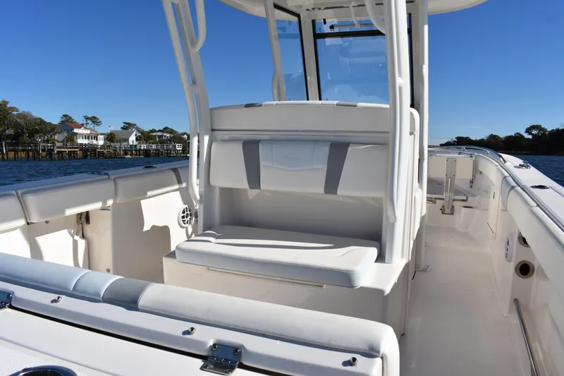 Slide: The Image of 2022 Robalo R272 Center Console boat interior with seating and console view. - 24
