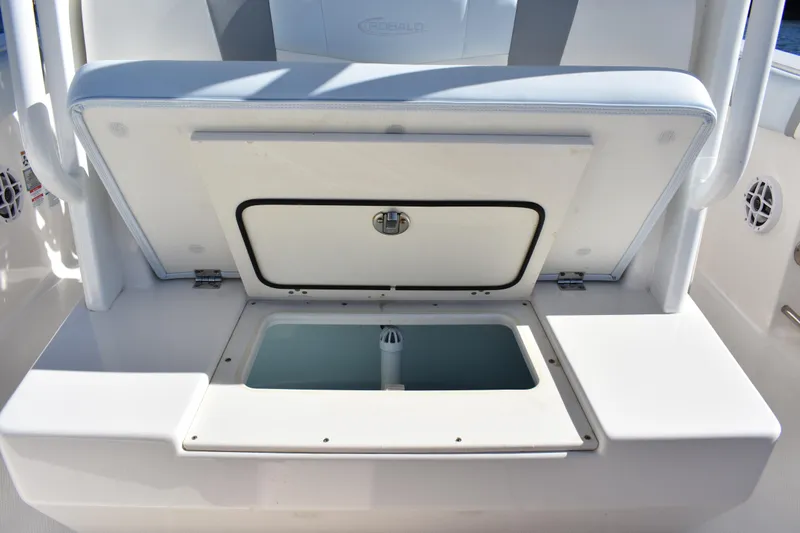Slide: The Image of 2022 Robalo R272 Center Console boat with open storage compartment. - 26