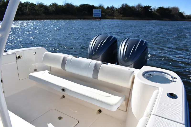 Slide: The Image of 2022 Robalo R272 Center Console boat with twin engines on a sunny day. - 27