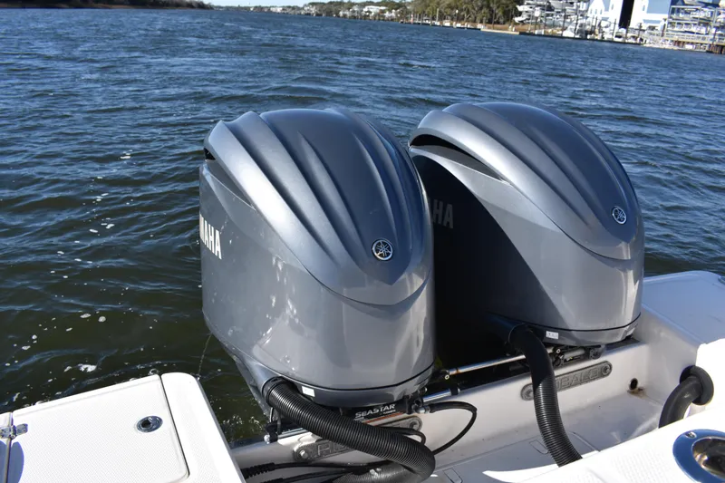 Slide: The Image of Twin Yamaha outboard engines on a 2022 Robalo R272 Center Console boat. - 29