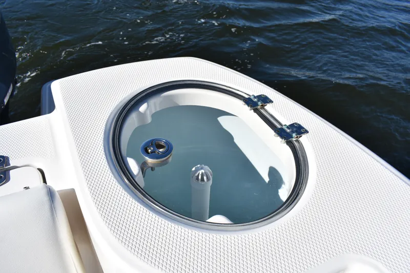 Slide: The Image of 2022 Robalo R272 Center Console livewell on deck, with ocean background. - 32