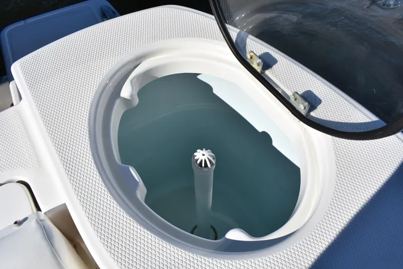 Slide: The Image of 2022 Robalo R272 Center Console livewell with open lid, showcasing interior design. - 33