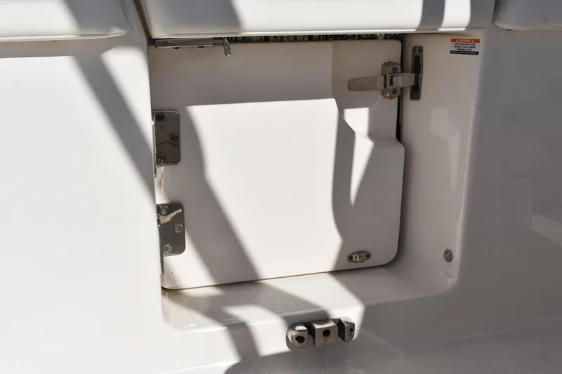 Slide: The Image of 2022 Robalo R272 Center Console storage compartment with secure latch and hinges. - 34