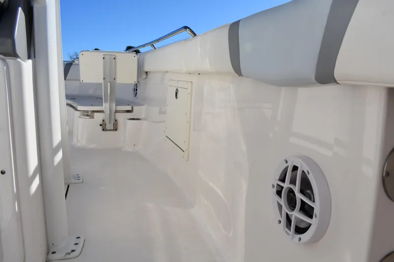 Slide: The Image of 2022 Robalo R272 Center Console boat interior with speaker and storage compartment. - 36