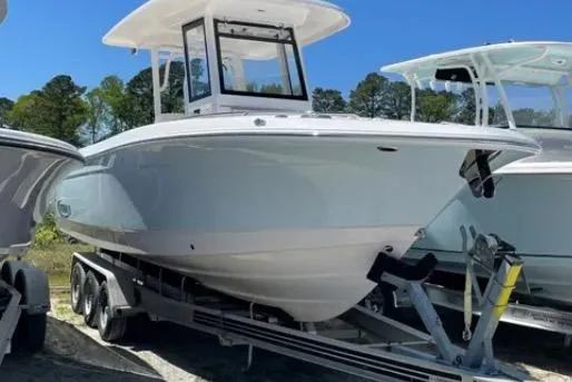 Slide: The Image of 2022 Robalo R272 Center Console boat on water, twin Yamaha engines, scenic background. - 4