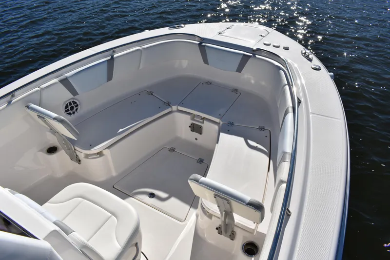 Slide: The Image of 2022 Robalo R272 Center Console boat interior with seating and storage on water. - 7