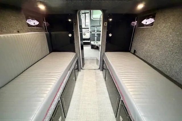 Slide: The Image of Interior of a 2017 Life Proof 33 boat with gray seating and storage compartments. - 11
