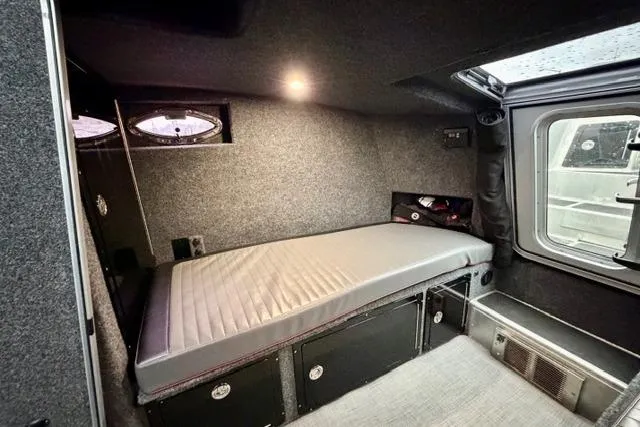 Slide: The Image of Compact interior of 2017 Life Proof 33 with a single bed and storage compartments. - 12