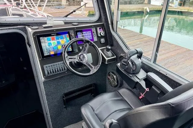 Slide: The Image of Cockpit of 2017 Life Proof 33 boat with modern navigation controls and steering wheel. - 16