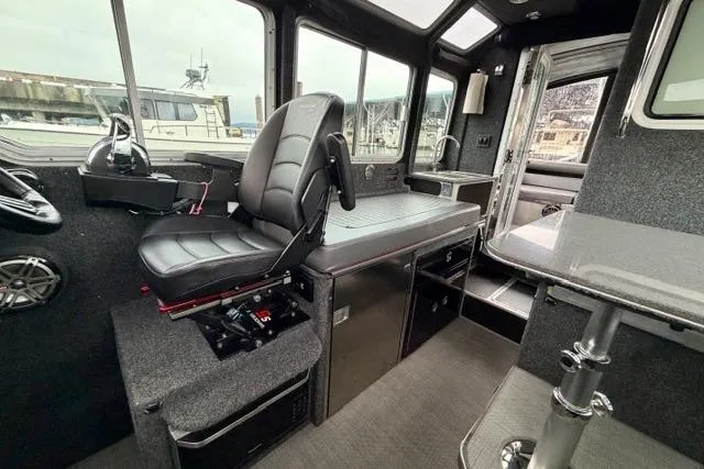 Slide: The Image of Interior of a 2017 Life Proof 33 boat with modern seating and control panel. - 17