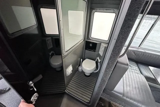 Slide: The Image of Interior of a 2017 Lifeproof 33 boat featuring a compact bathroom. - 2