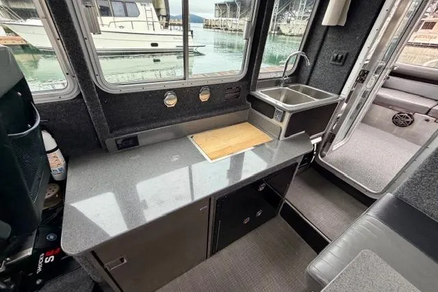 Slide: The Image of Interior of 2017 Life Proof 33 boat with kitchenette and sink, docked at marina. - 23
