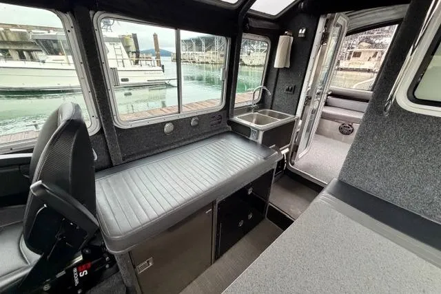 Slide: The Image of Interior of 2017 Life Proof 33 boat with seating, sink, and marina view. - 24