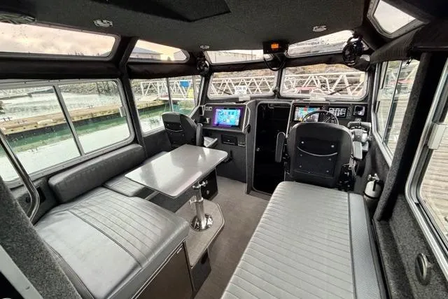 Slide: The Image of 2017 Life Proof 33 boat interior with seating, table, and navigation equipment. - 25