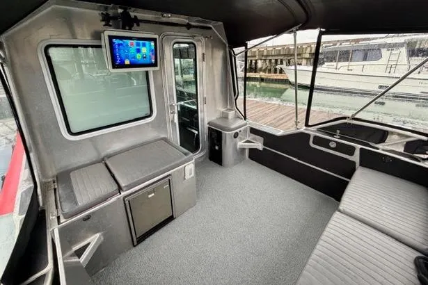 Slide: The Image of Interior of 2017 Life Proof 33 boat with seating, TV, and dock view. - 27