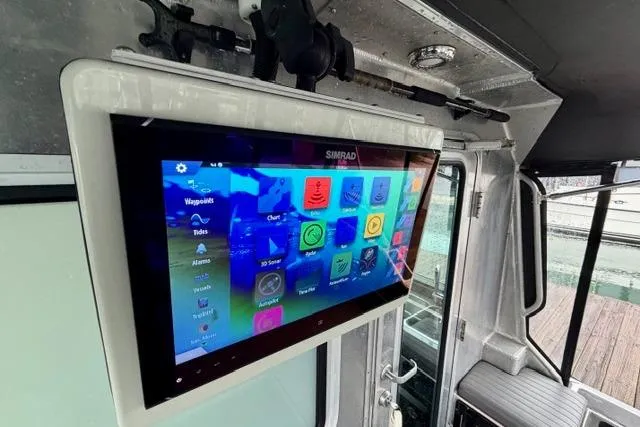 Slide: The Image of Touchscreen navigation system on a 2017 Life Proof 33 boat, displaying various marine apps. - 28