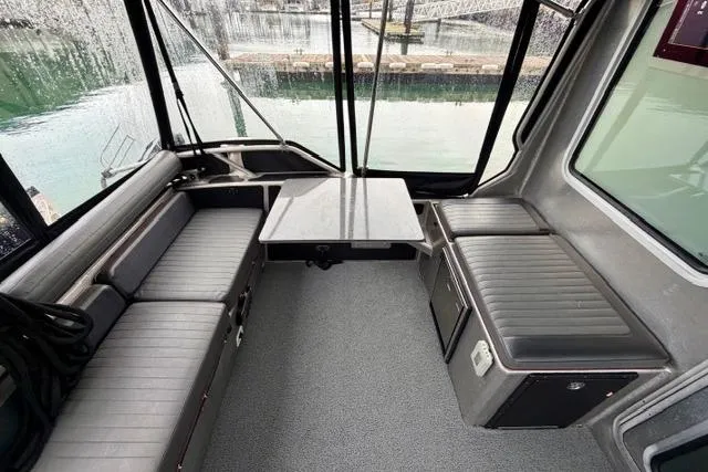 Slide: The Image of Interior of 2017 Life Proof 33 boat with seating and table, dockside view. - 29