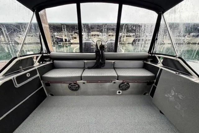 Slide: The Image of Interior of a 2017 Life Proof 33 boat with seating and marina view. - 31