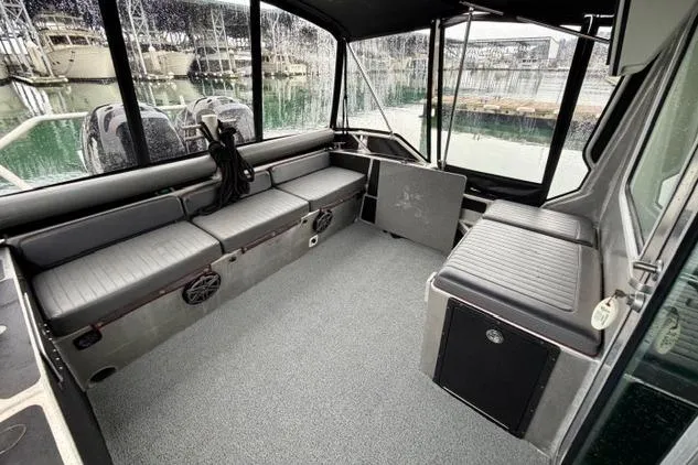 Slide: The Image of Interior of a 2017 Life Proof 33 boat with seating and windows overlooking a marina. - 32
