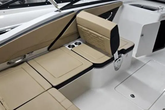 Slide: The Image of 2026 Sea Ray SPX 210 Outboard interior with beige seating and cup holders. - 3